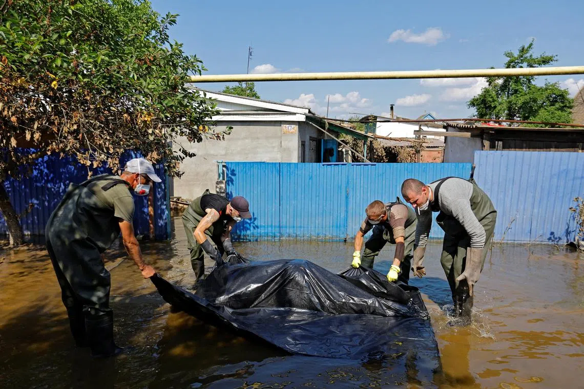 A body is retrieved from a flooded house in Russian-occupied Ukraine. 