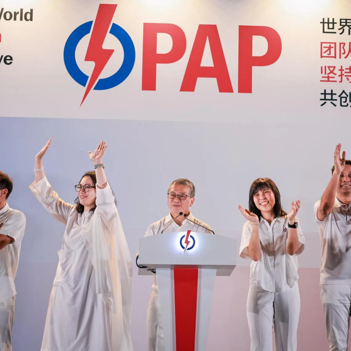 The PAP's East Coast GRC candidates (from left) Tan Kiat How, Hazlina Abdul Halim, Edwin Tong, Jessica Tan and Dinesh Vasu Dash thanking their supporters at Bedok Stadium on May 4.