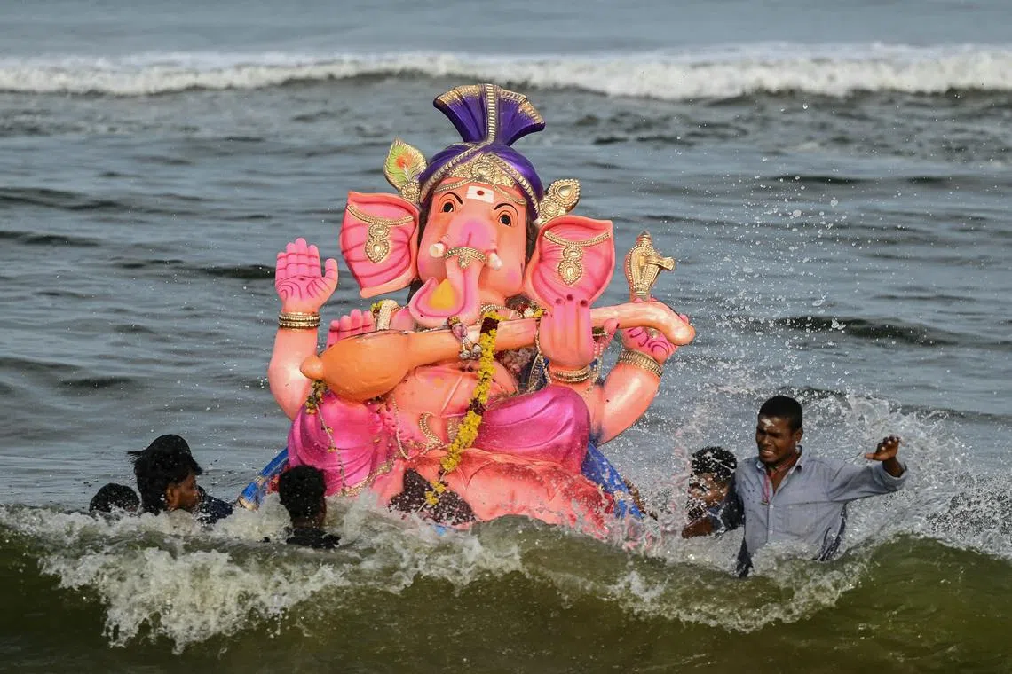 Hindu devotees carrying an idol of the elephant-headed Hindu god Ganesha for immersion in the Bay of Bengal during the 'Ganesh Chaturthi' festival in Chennai on Sep 9, 2024. 