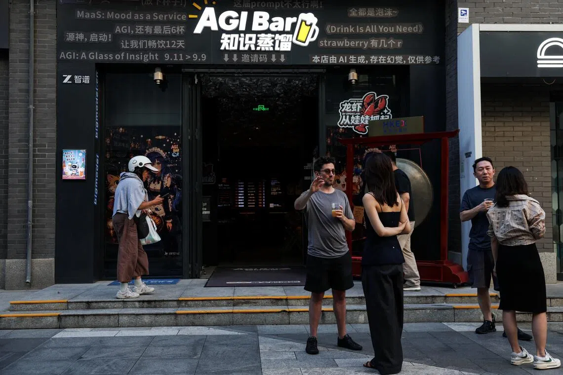 Customers chat in front of the AI-themed bar AGI Bar in Beijing’s high-tech neighbourhood of Zhongguancun.