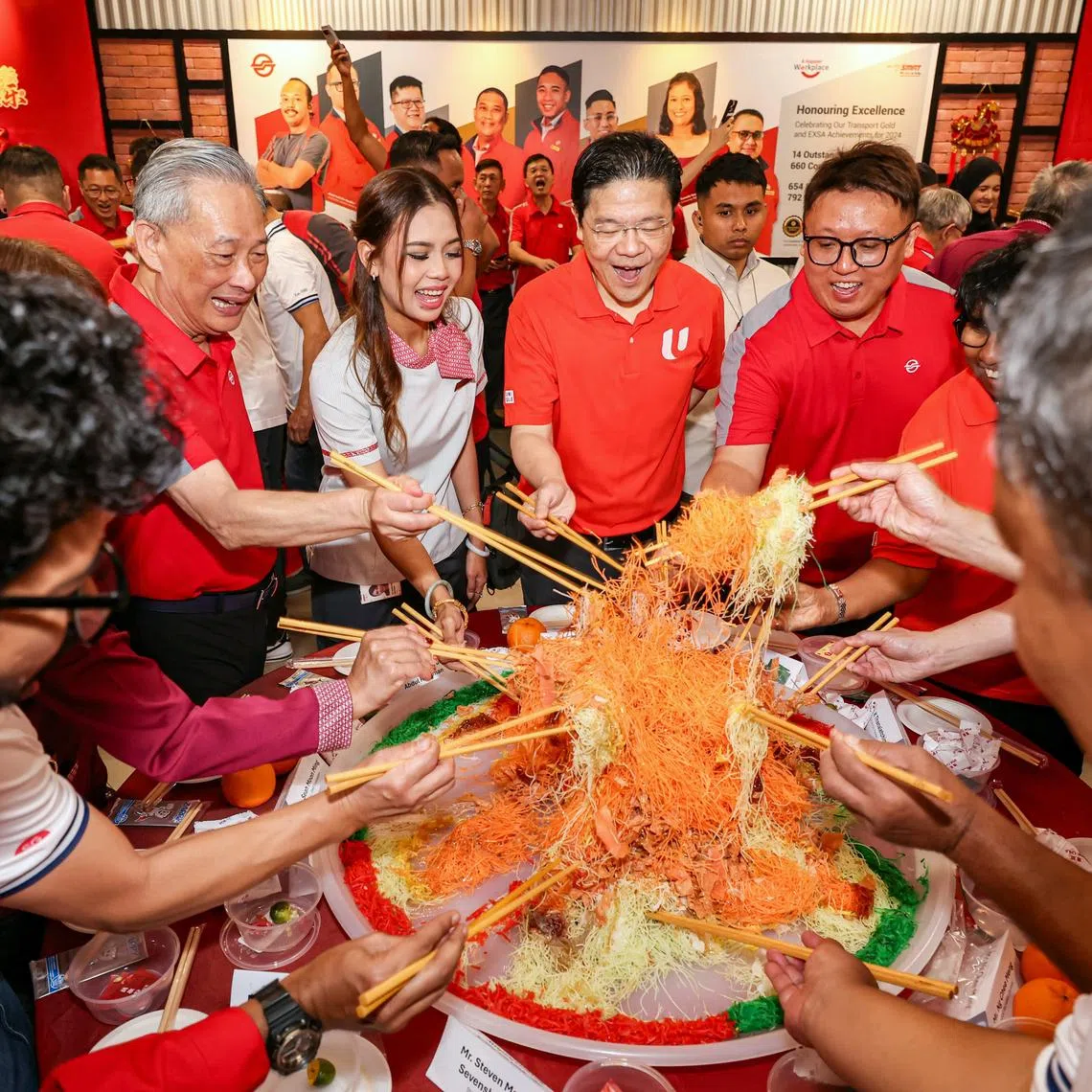 PM Lawrence Wong participating in a mass lo hei (tossing of yusheng) during his visit to SMRT’s Bishan depot on Feb 16.