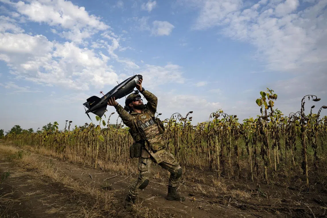  A Ukrainian soldier preparing to release a drone that will fly over Russian-occupied territory in search of heavy weapons and air defense installations, in the Zaporizhzhia region of Ukraine, Sept. 14, 2023. A fleet of inexpensive, mostly off-the-shelf drones is helping Ukrainian forces evade and target sophisticated Russian air defense systems. (Lynsey Addario/The New York Times) — NO SALES. —