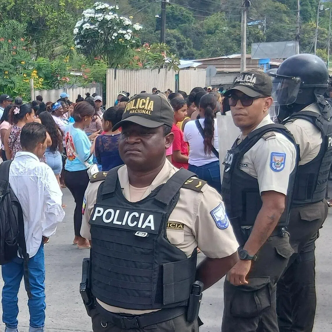 Police officers standing guard at a prison in Esmeraldas, Ecuador, on Sept 25, after clashes left at least 17 people dead.
