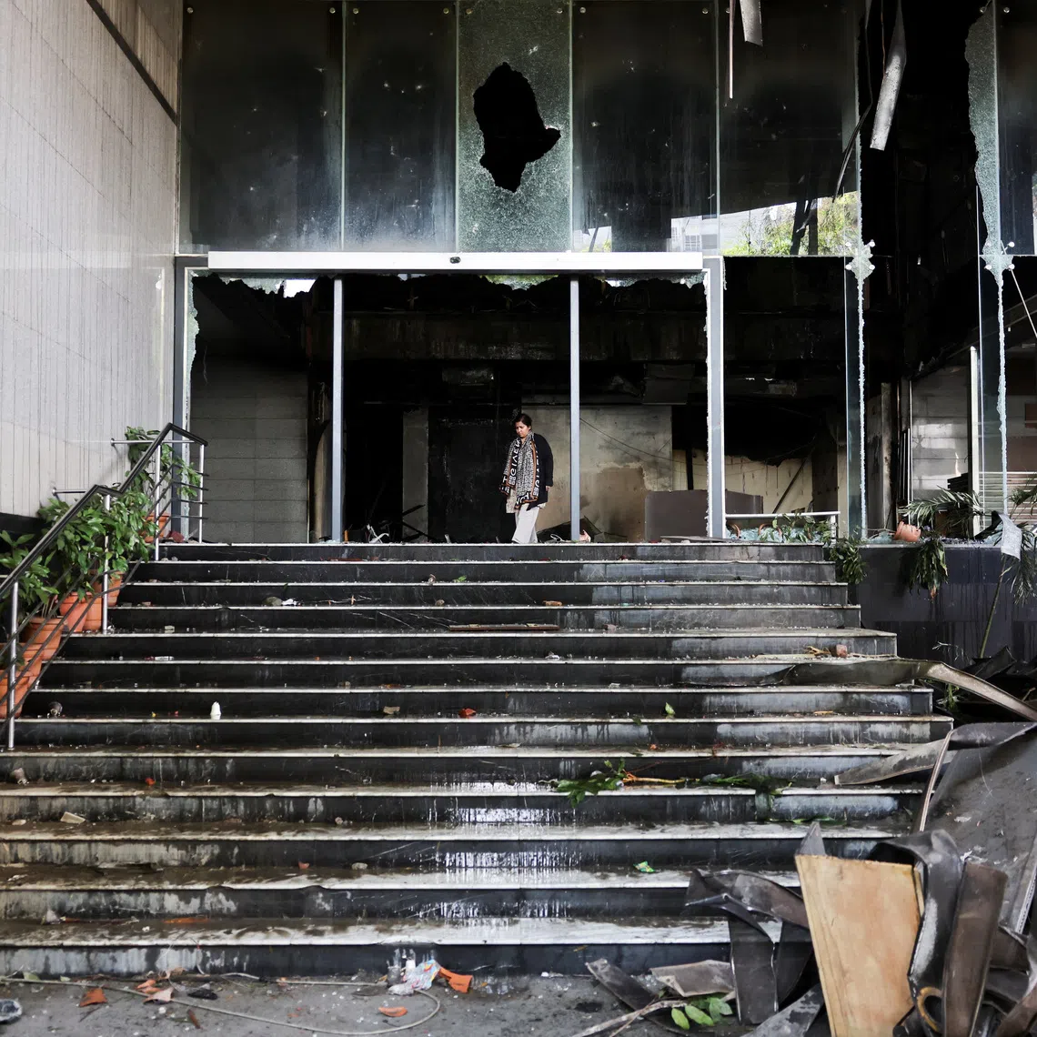 A woman walks at the vandalised basement of the Daily Star building, following the death of Sharif Osman Hadi, a student leader, who had been undergoing treatment in Singapore after being shot in the head, in Dhaka, Bangladesh, December 19, 2025. REUTERS/Mohammad Ponir Hossain