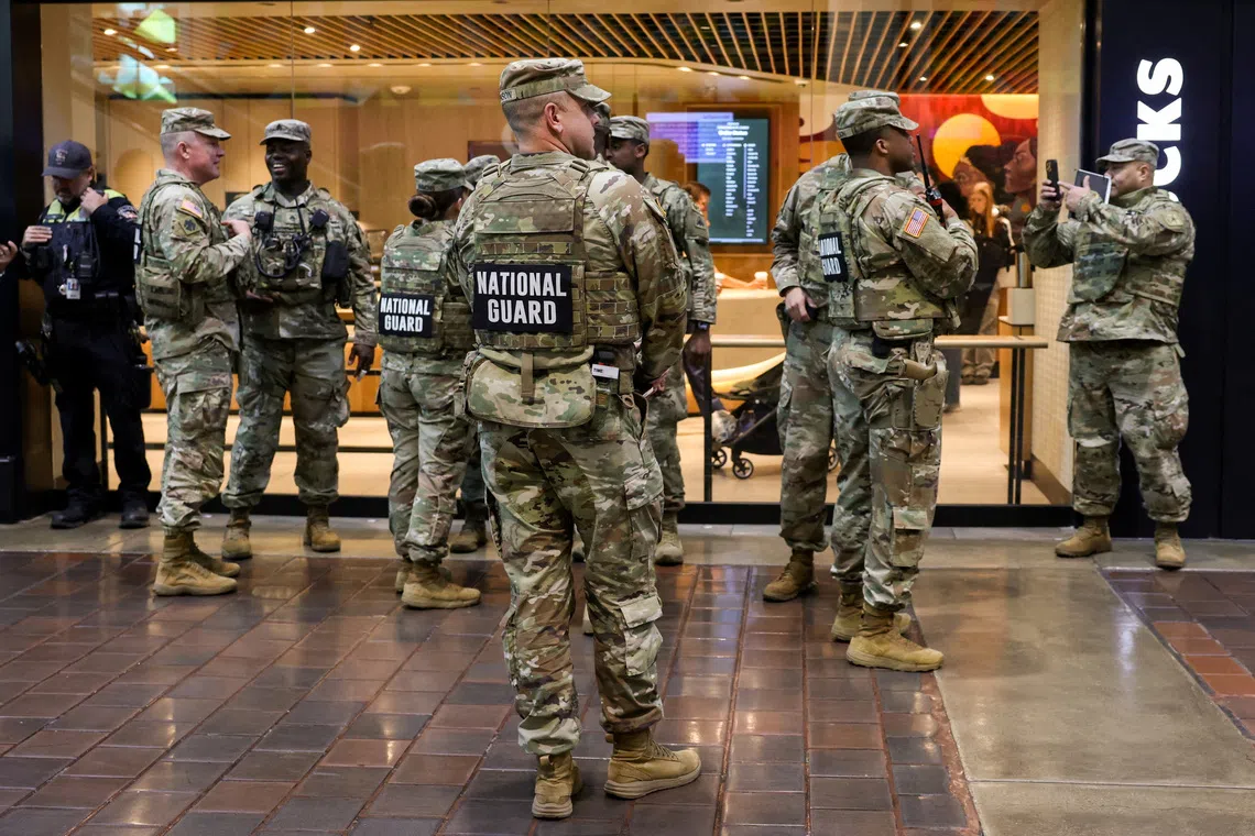 FILE PHOTO: Members of the National Guard stand at Union Station, in Washington, D.C., U.S., October 27, 2025. REUTERS/Kylie Cooper/File Photo