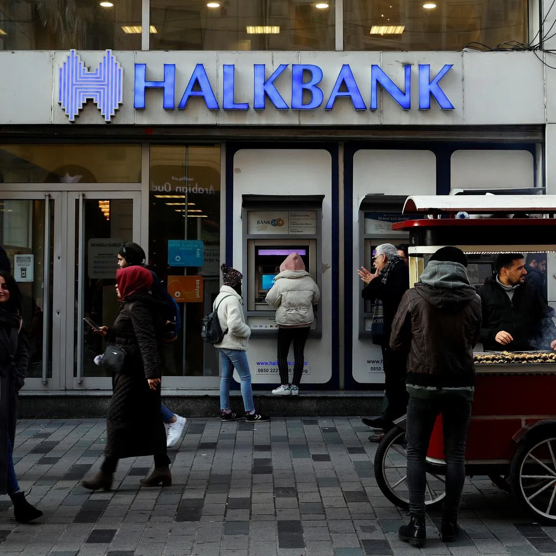 FILE PHOTO: People walk past by a branch of Halkbank in central Istanbul, Turkey, January 22, 2020. REUTERS/Murad Sezer/File Photo