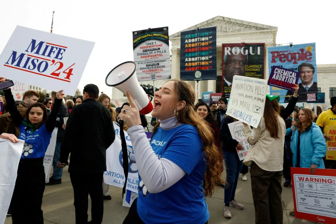 FILE PHOTO: A demonstrator for abortion rights uses a megaphone during a protest outside the U.S. Supreme Court as justices hear oral arguments in a bid by President Joe Biden's administration to preserve broad access to the abortion pill, in Washington, U.S., March 26, 2024. REUTERS/Evelyn Hockstein/File Photo