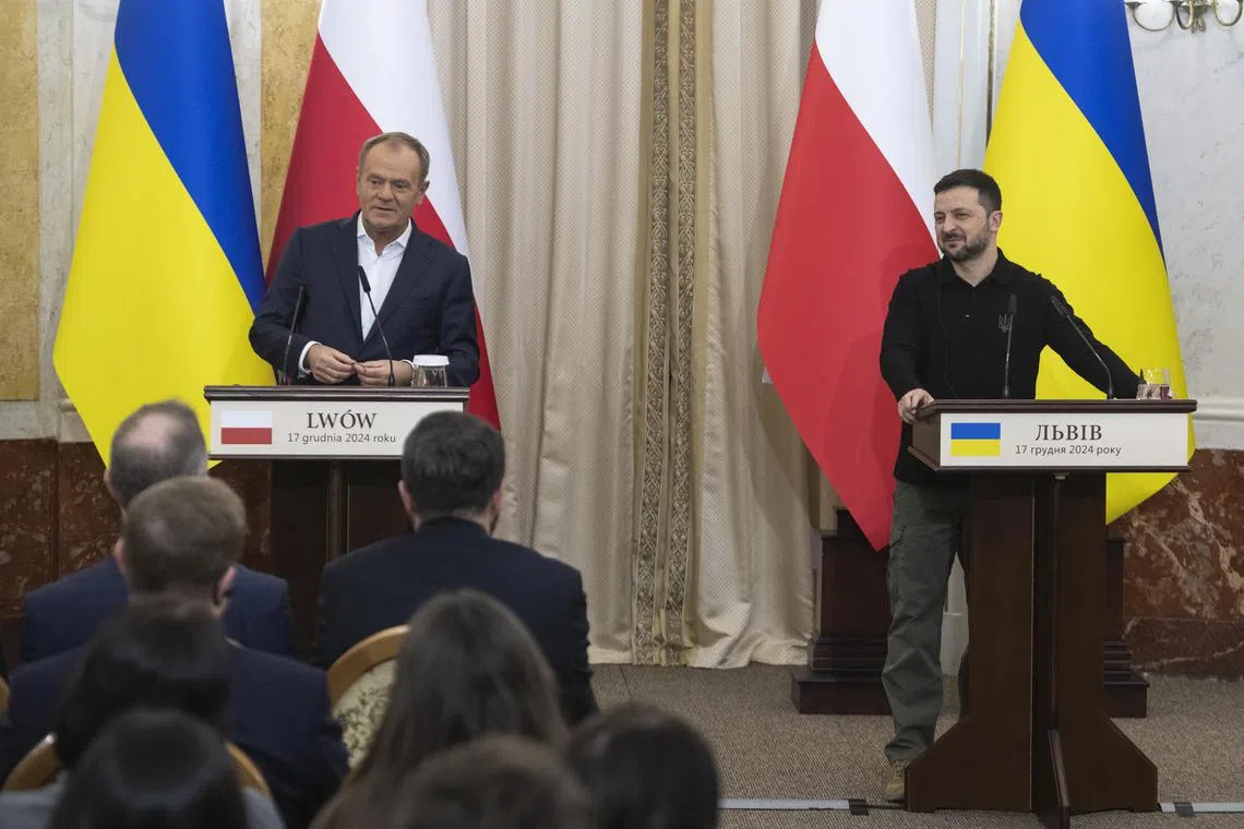 Ukrainian President Volodymyr Zelensky (right) and Polish Prime Minister Donald Tusk giving a press briefing after a meeting in Lviv, Ukraine, on Dec 17.