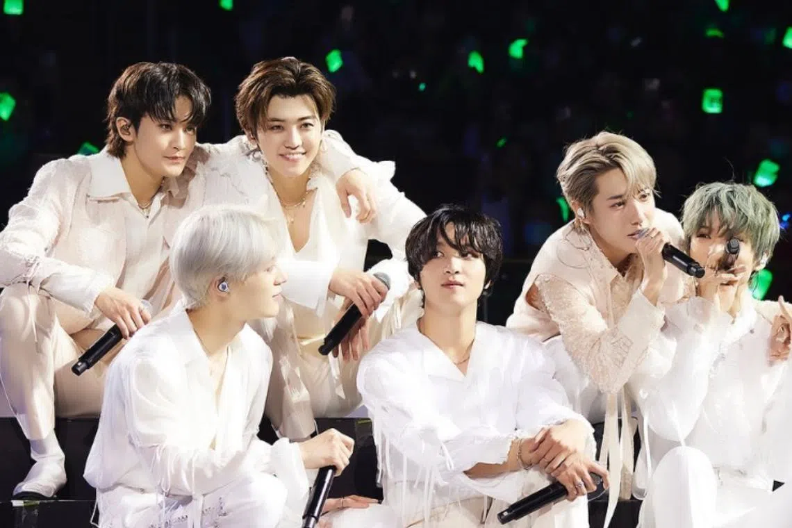 NCT Dream's (clockwise from top right) Mark, Jaemin, Renjun, Jisung, Haechan and Jeno performing in Singapore. 