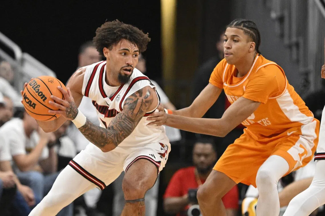 Nov 9, 2024; Louisville, Kentucky, USA;  Louisville Cardinals guard J'Vonne Hadley (1) controls the ball as Tennessee Volunteers guard Cameron Carr (43) defends during the first half at KFC Yum! Center. Tennessee defeated Louisville 77-55. Mandatory Credit: Jamie Rhodes-Imagn Images/ File Photo