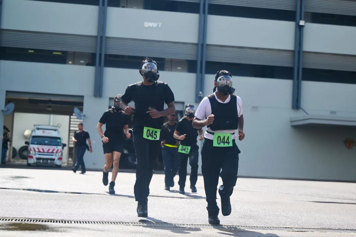 The Singapore Prison Service?s (SPS) Singapore Prisons Emergency Action Response (SPEAR) Force candidates running with gas masks on during the annual selection and assessment on Oct 1. 

Only one out of the five candidates have made it through the selection this year. 

The SPEAR Force is an elite tactical unit trained to respond to emergencies and mitigate unrest within the prison institutions. 

ST PHOTO: AZMI ATHNI