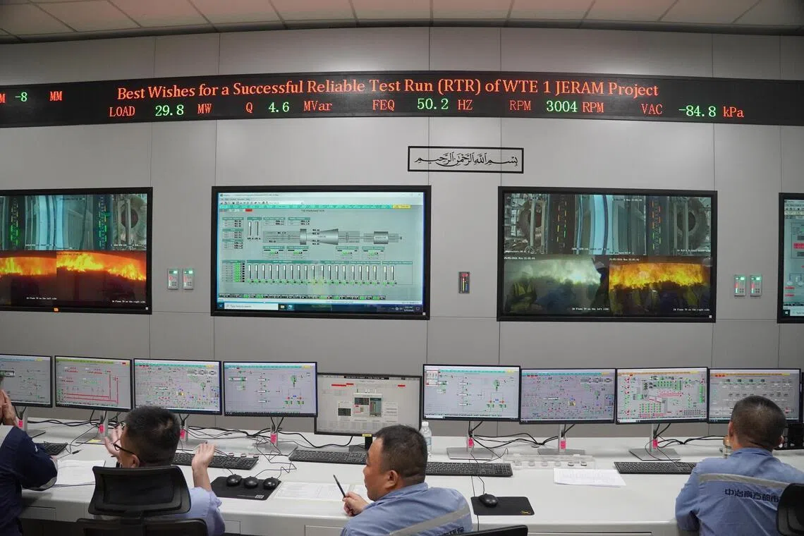 Technicians and engineers monitor the rubbish incineration process in the control room, which shows 29.8MW of power generation, exceeding the projected capacity of 25MW. 