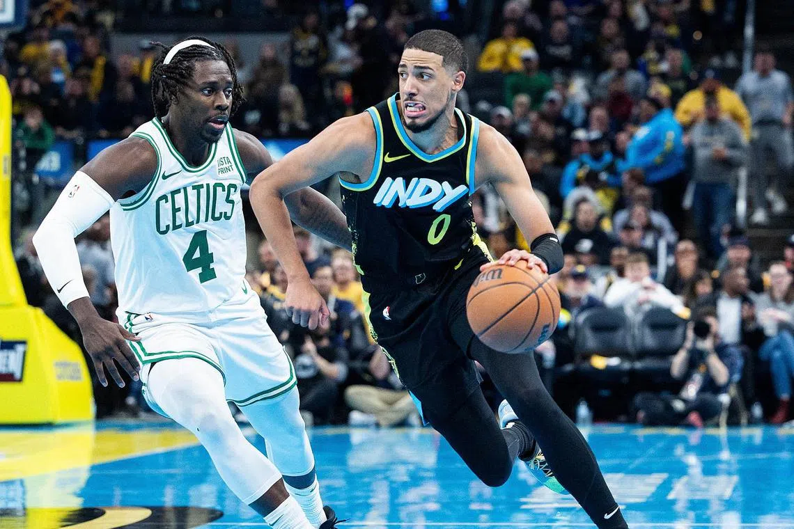 Indiana Pacers guard Tyrese Haliburton (right) drives with the ball against Boston Celtics guard Jrue Holiday during their NBA match on Dec 4.