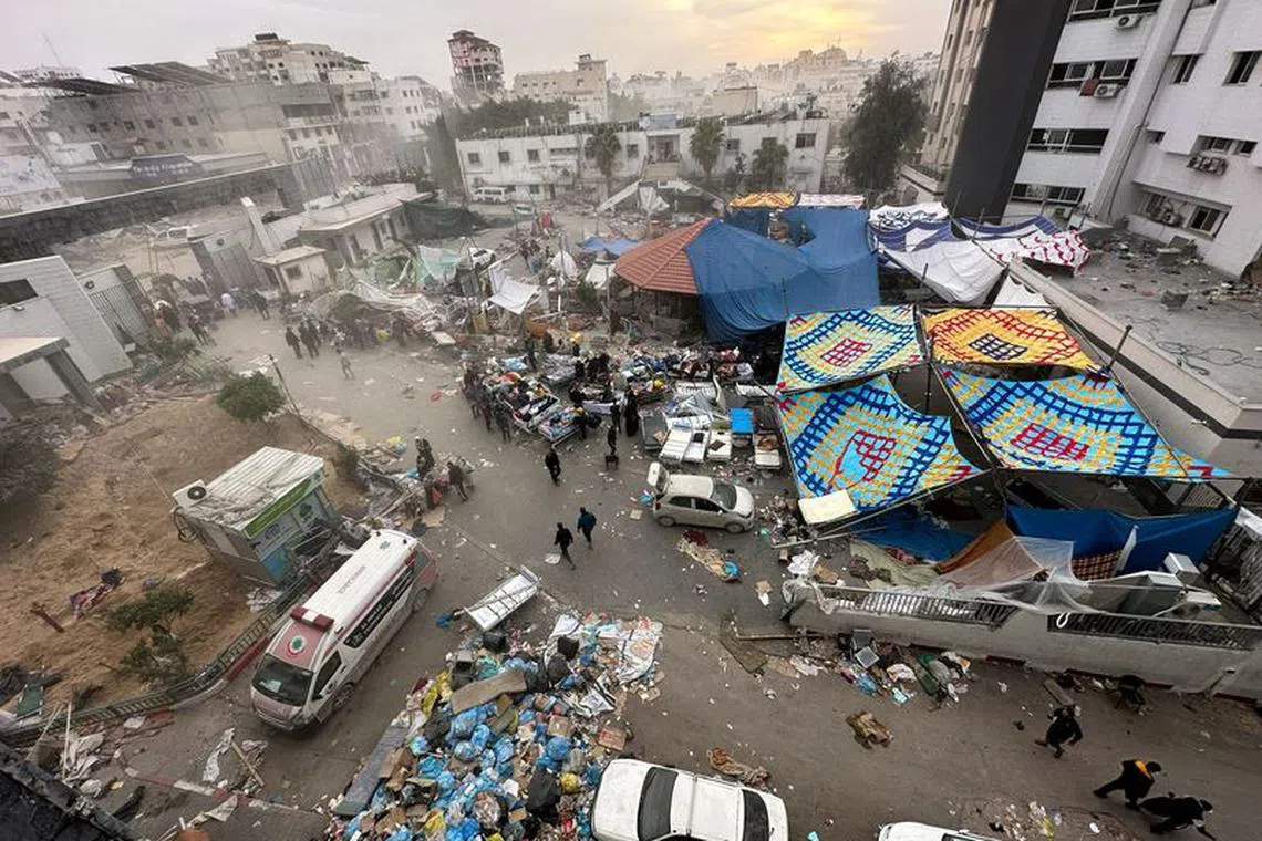 FILE PHOTO: Palestinians inspect Al Shifa Hospital which was raided by Israeli forces during its ground operation, amid a temporary truce between Israel and the Palestinian Islamist group Hamas, in Gaza City,  November 25, 2023. REUTERS/Abed Sabah/File Photo