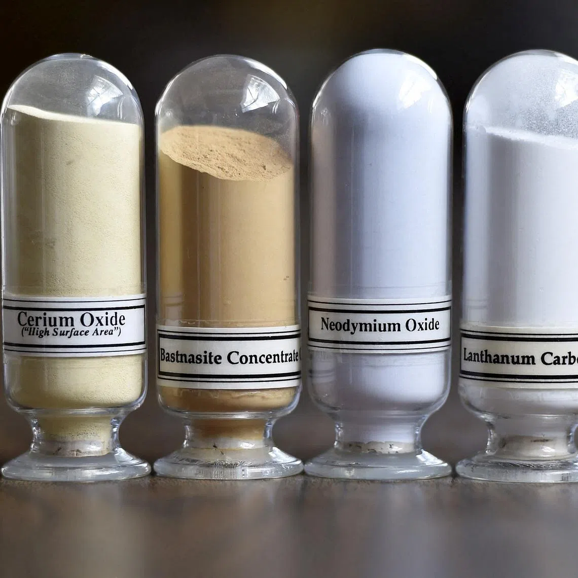 FILE PHOTO: Samples of rare earth minerals from left, Cerium oxide, Bastnasite, Neodymium oxide and Lanthanum carbonate are on display during a tour of Molycorp's Mountain Pass Rare Earth facility in Mountain Pass, California June 29, 2015.  REUTERS/David Becker/File Photo
