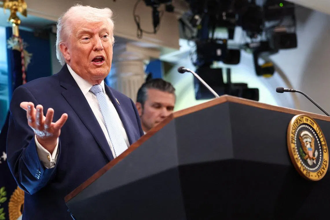 FILE PHOTO: U.S. President Donald Trump, flanked by Secretary of Defense Pete Hegseth, speaks during a press conference in the James S. Brady Press Briefing Room at the White House in Washington, D.C., U.S., April 6, 2026. REUTERS/Kevin Lamarque/File Photo