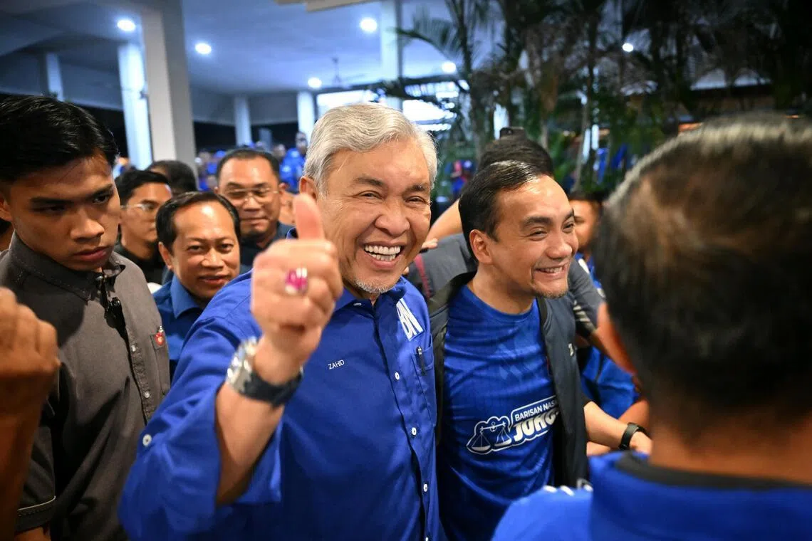 Deputy Prime Minister Zahid Hamidi (left) and Johor Menteri Besar Onn Hafiz Ghazi cheering Barisan Nasional’s win in the Johor state election on July 11.