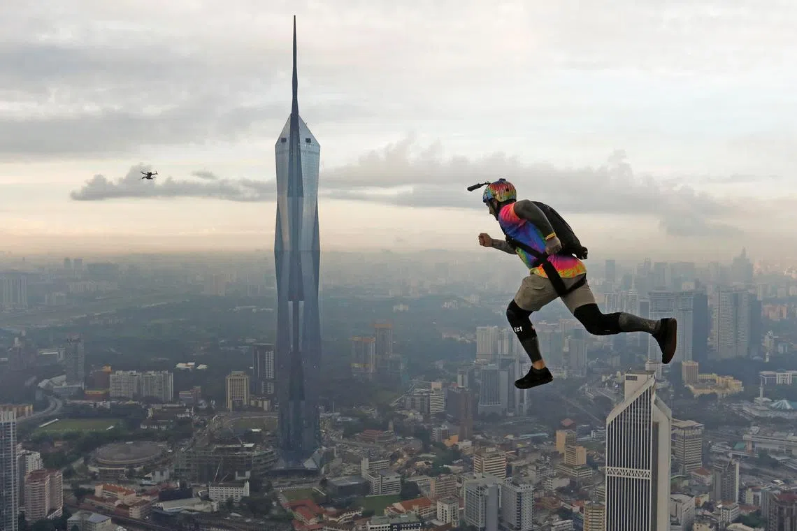 A base jumper leaps off the Kuala Lumpur Tower during the annual KL Tower International Jump Malaysia 2023 at Kuala Lumpur, Malaysia, Feb 3, 2023.