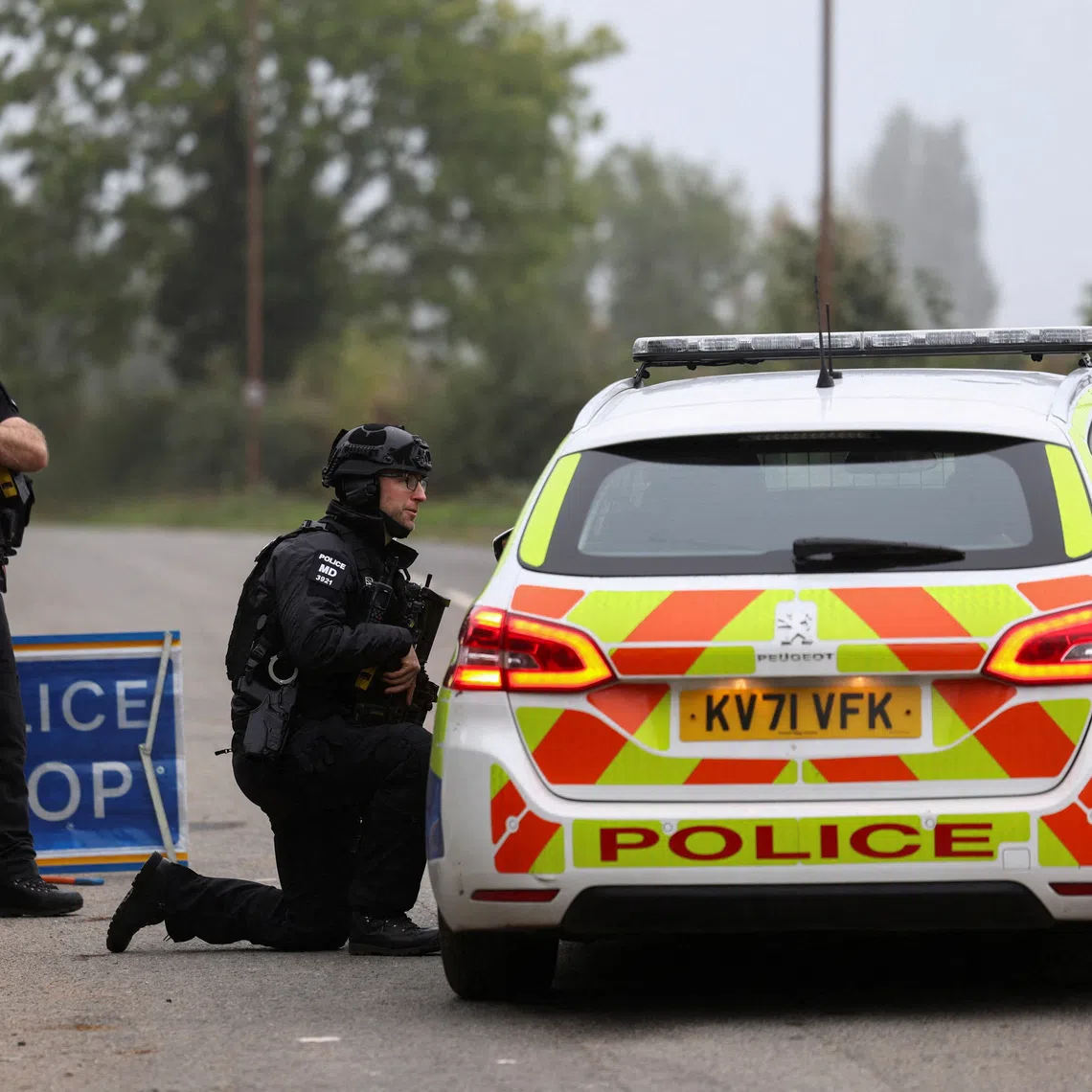 Police officers guard an area as roadblocks remain in place near RAF Fairford airbase, after police declared a major incident at the base and arrested several men on suspicion of offences under the Explosives Act, who have since been released on bail, in Fairford, Gloucestershire, Britain, September 29, 2026. REUTERS/Toby Shepheard