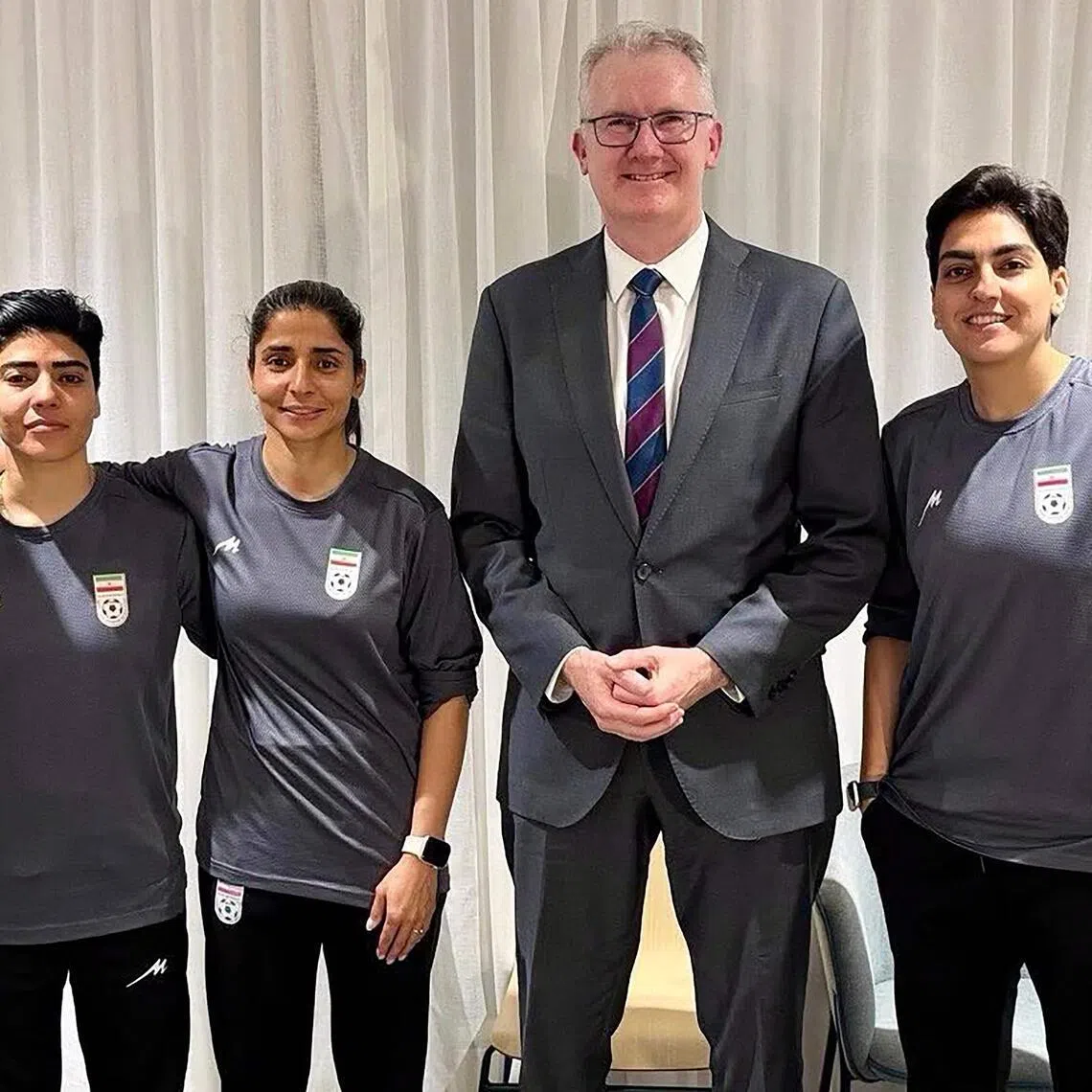 Australia's Home Affairs minister Tony Burke with five Iranian women footballers who applied for asylum after the Asian Cup.
