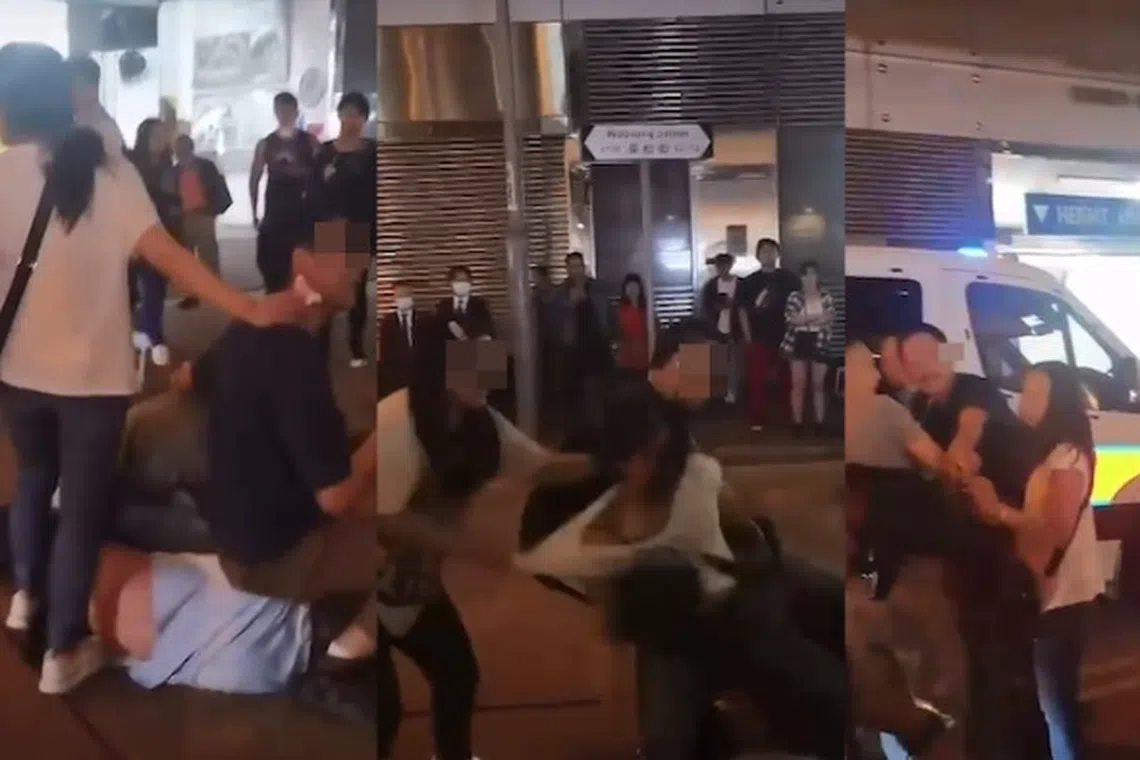 Videos showed a man in a light blue T-shirt lying on his side as two men pinned him to the ground.