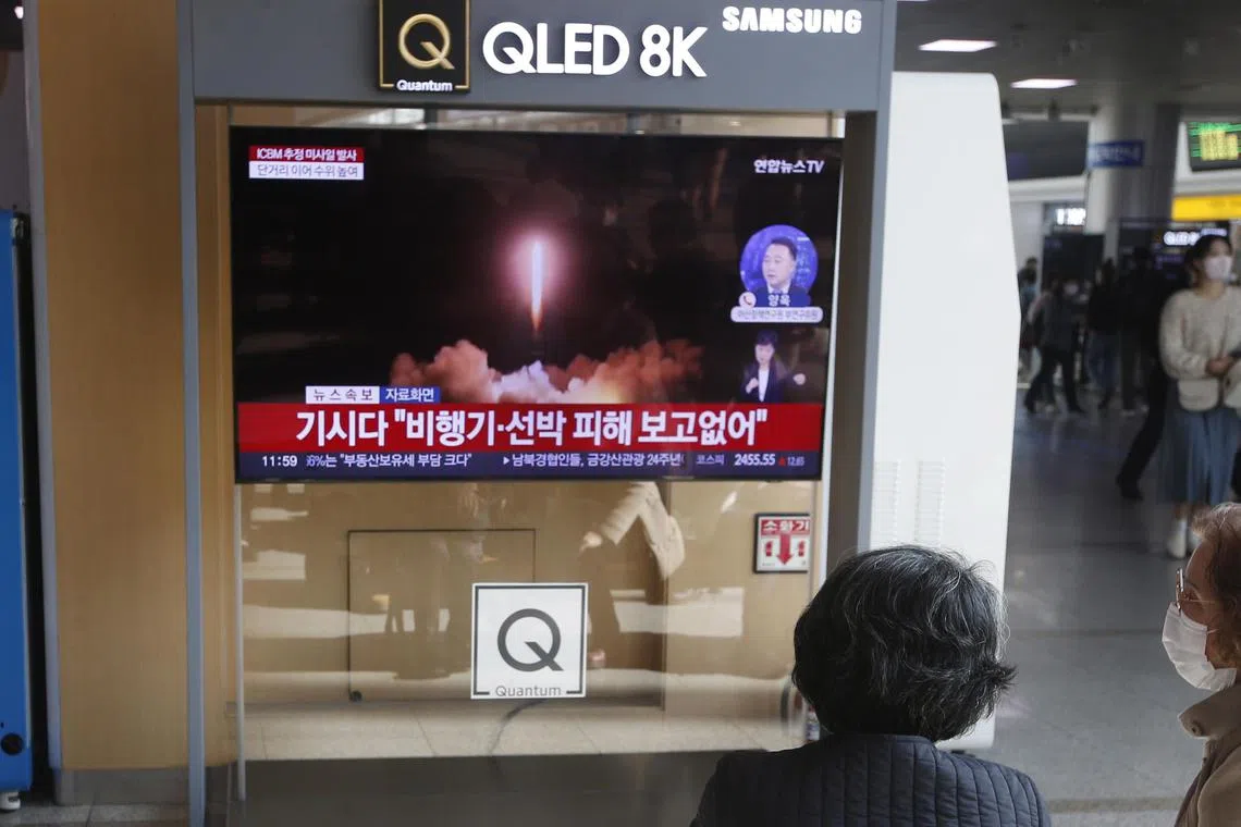 People watch the news at a station in Seoul, South Korea on Nov 18, 2022 after North Korea launched an ICBM into the Japan's EEZ.   