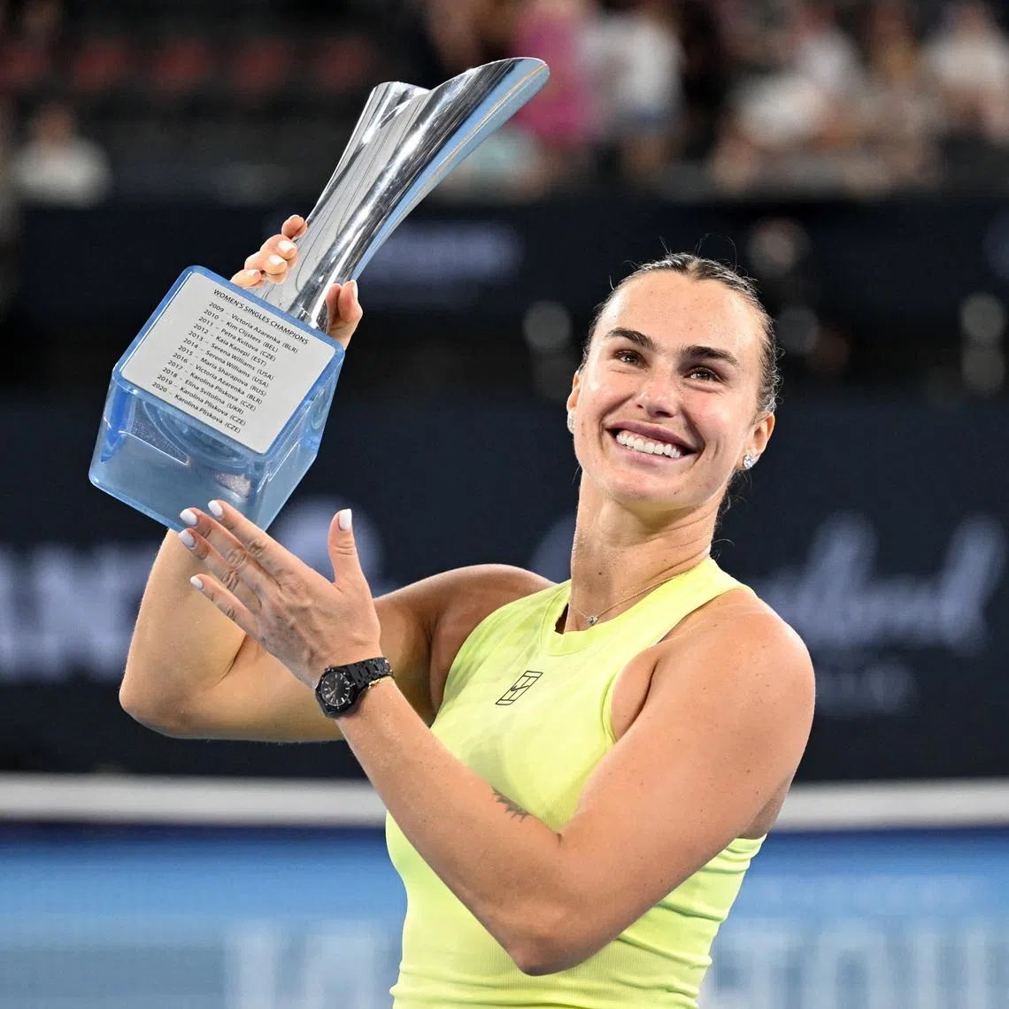 Tennis - Brisbane International Tennis Tournament - Pat Rafter Arena, Brisbane, Australia - January 11, 2026 Belarus' Aryna Sabalenka celebrates with the trophy after winning the final against Ukraine's Marta Kostyuk REUTERS/Dan Peled