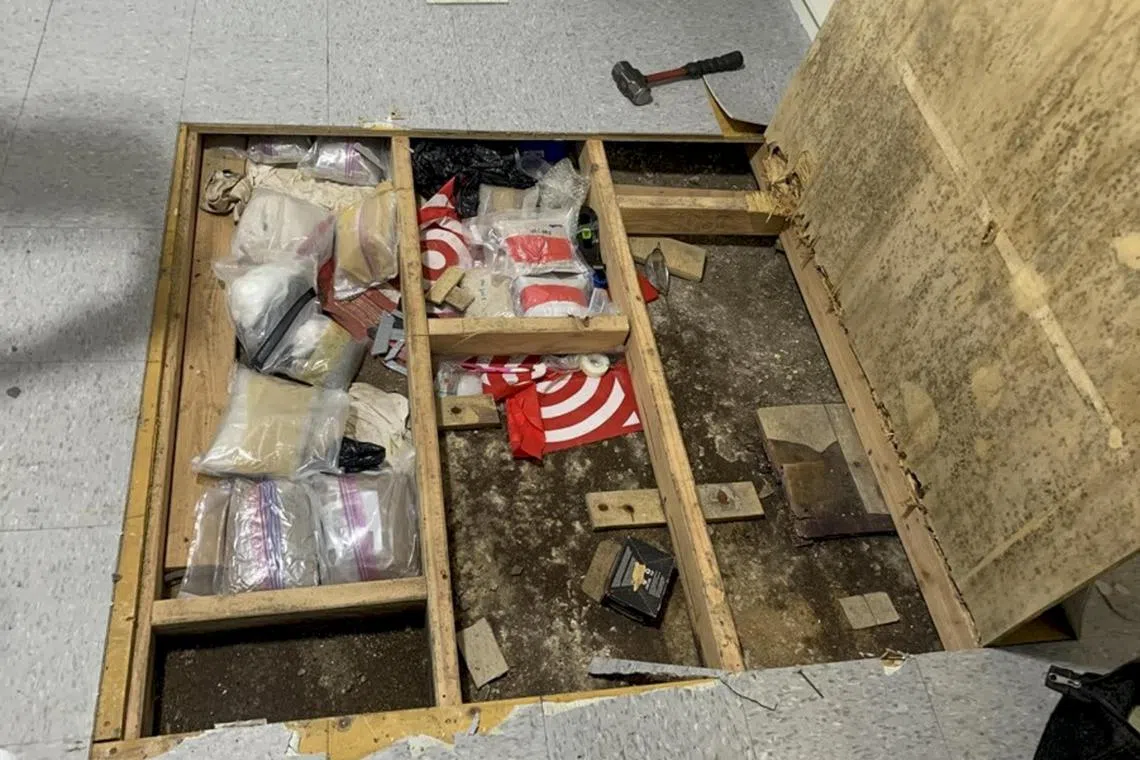 A photo provided by NYPD shows a trap floor discovered in the play area at Divino Niño, a day care in an apartment in the Bronx. Days after a 1-year-old died and three children exposed to drugs at a Bronx day care site were hospitalized, investigators uncovered a trap door under a play area that was hiding fentanyl, other narcotics and drug paraphernalia. (NYPD via The New York Times) — NO SALES; FOR EDITORIAL USE ONLY —