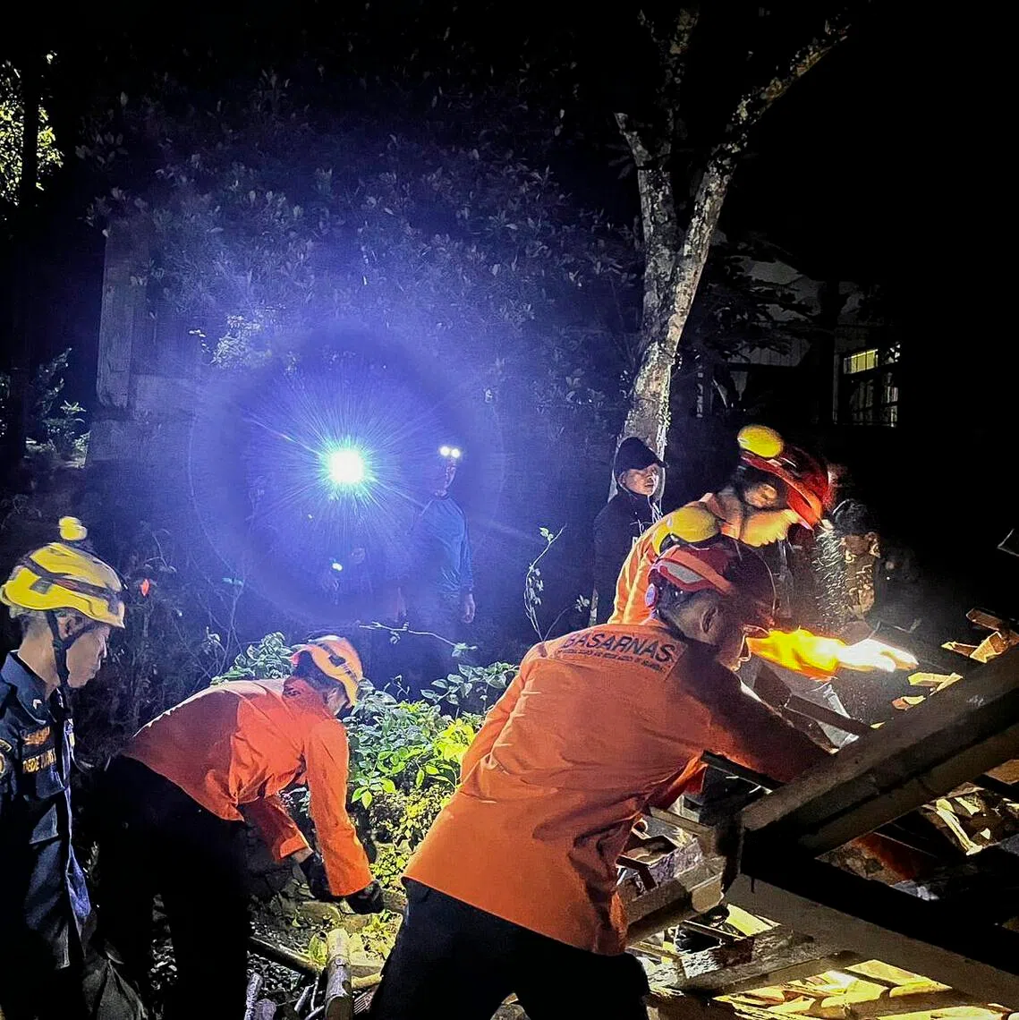 Rescuers searching for survivors after a landslide hit three villages in Cilacap, Indonesia, on the night of Nov 13.