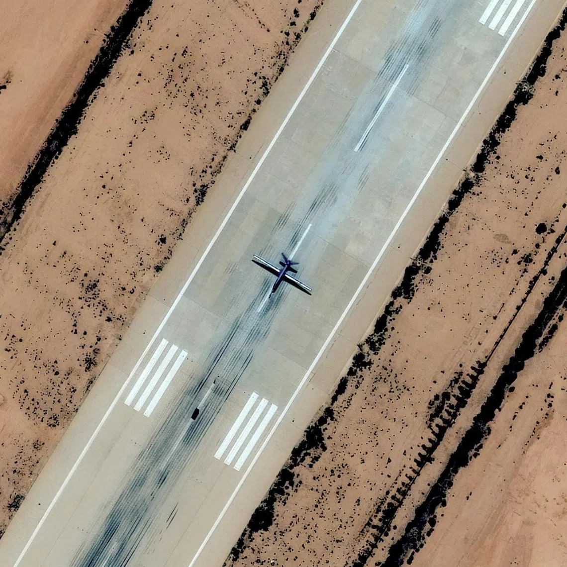 A satellite image shows a combat drone, which experts identified as most likely a Chinese-made Feilong-1, on the runway at Al Khadim airbase, east of Benghazi, Libya, May 3, 2025. Vantor/Handout via REUTERS