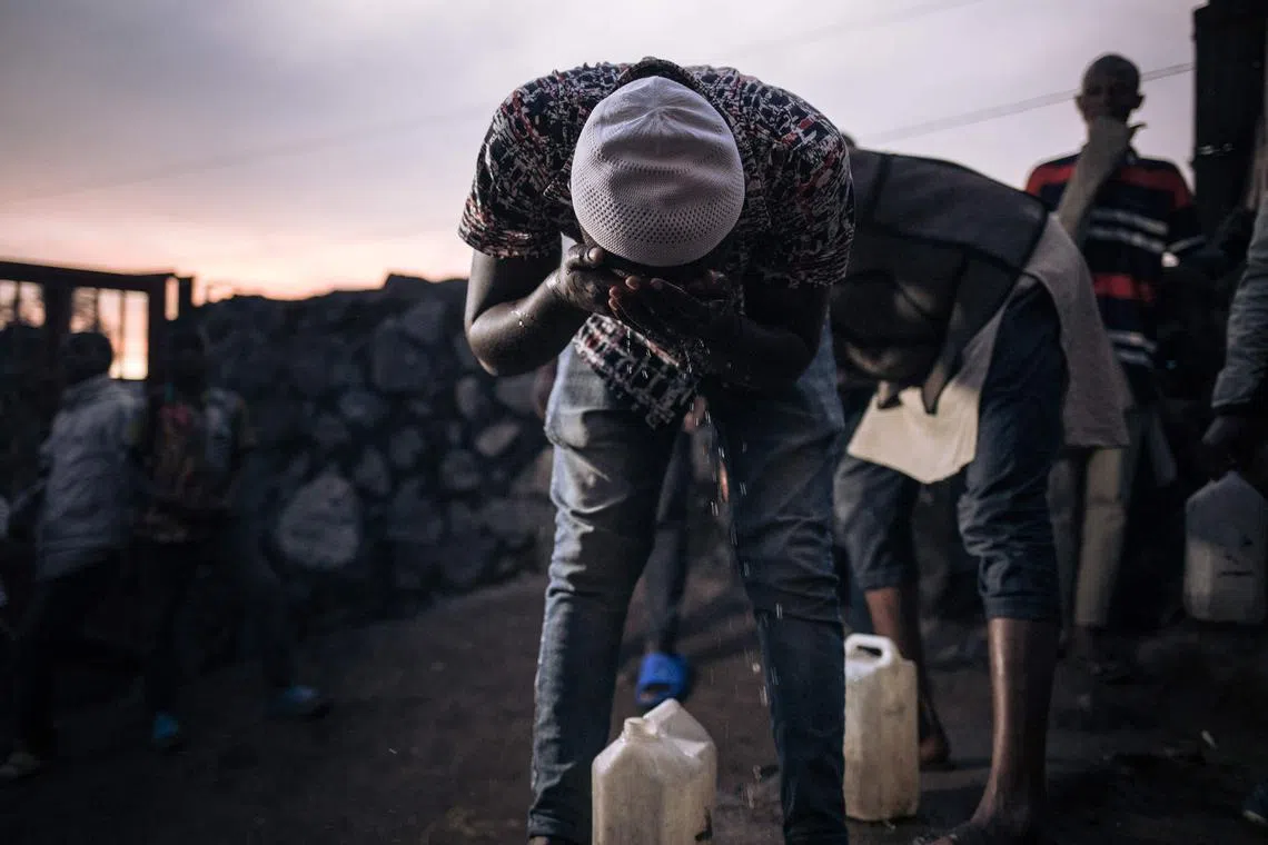 A displaced Muslim performs ablutions before the Ramadan fast-breaking prayer at an informal displacement camp in Goma, eastern Democratic Republic of Congo, March 27.