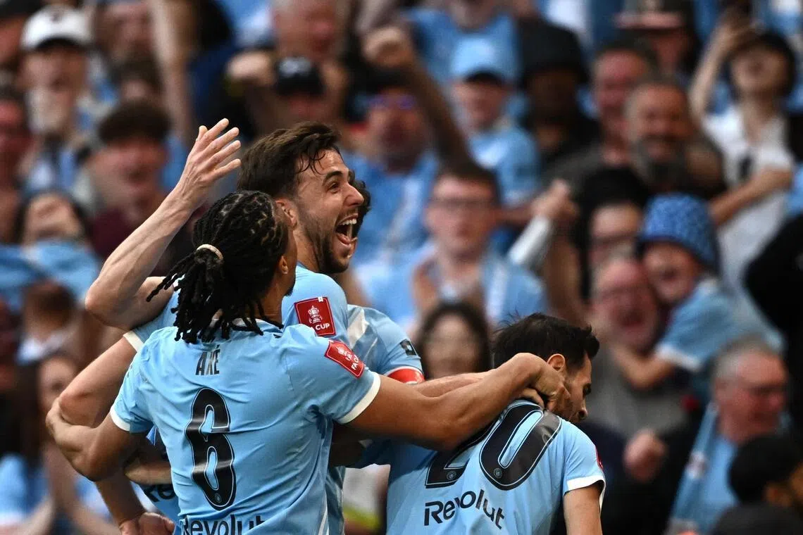 Manchester City's Nico Gonzalez celebrates scoring their second, winning goal in the 87th minute with Bernardo Silva and Nathan Ake.