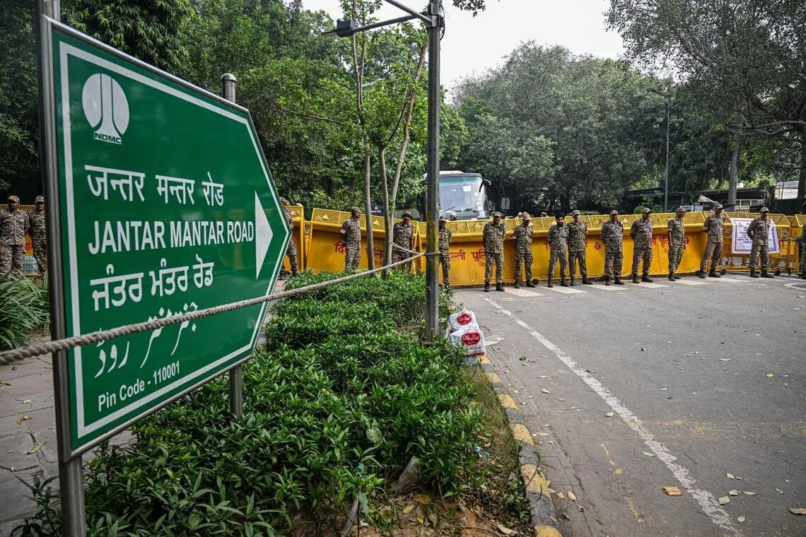 Police officers and paramilitary personnel stand guard outside Jantar Mantar ahead of a youth-led demonstration in New Delhi.