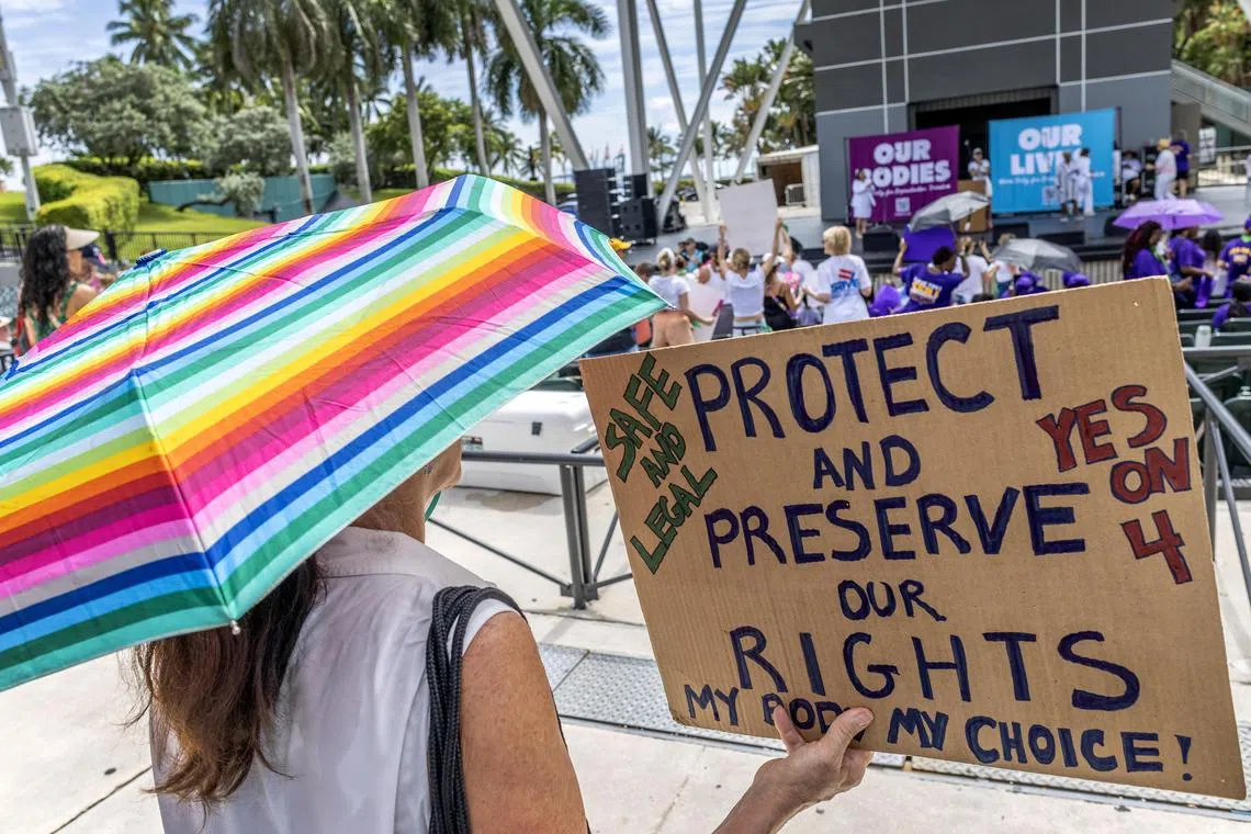 epa11604536 Supporters of the reproduction freedom show signs as they attend the rally 'Our Bodies Our Lives' organized by Florida Democratic Party in Miami, Florida, USA, 14 September 2024. As of 2024, Florida Governor DeSantis has signed into law significant abortion restrictions, including a ban on most abortions after six weeks of pregnancy. This law is among the strictest in the USA.  EPA-EFE/CRISTOBAL HERRERA-ULASHKEVICH