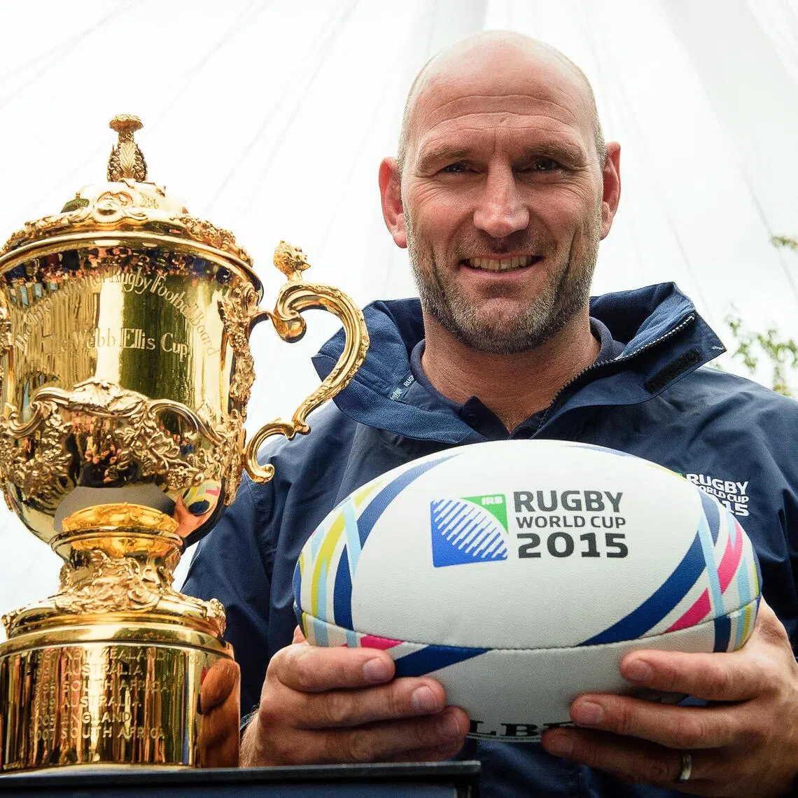 Lawrence Dallaglio poses with a rugby ball and the Webb Ellis Cup in London in ahead of the 2015 Rugby Union World Cup.