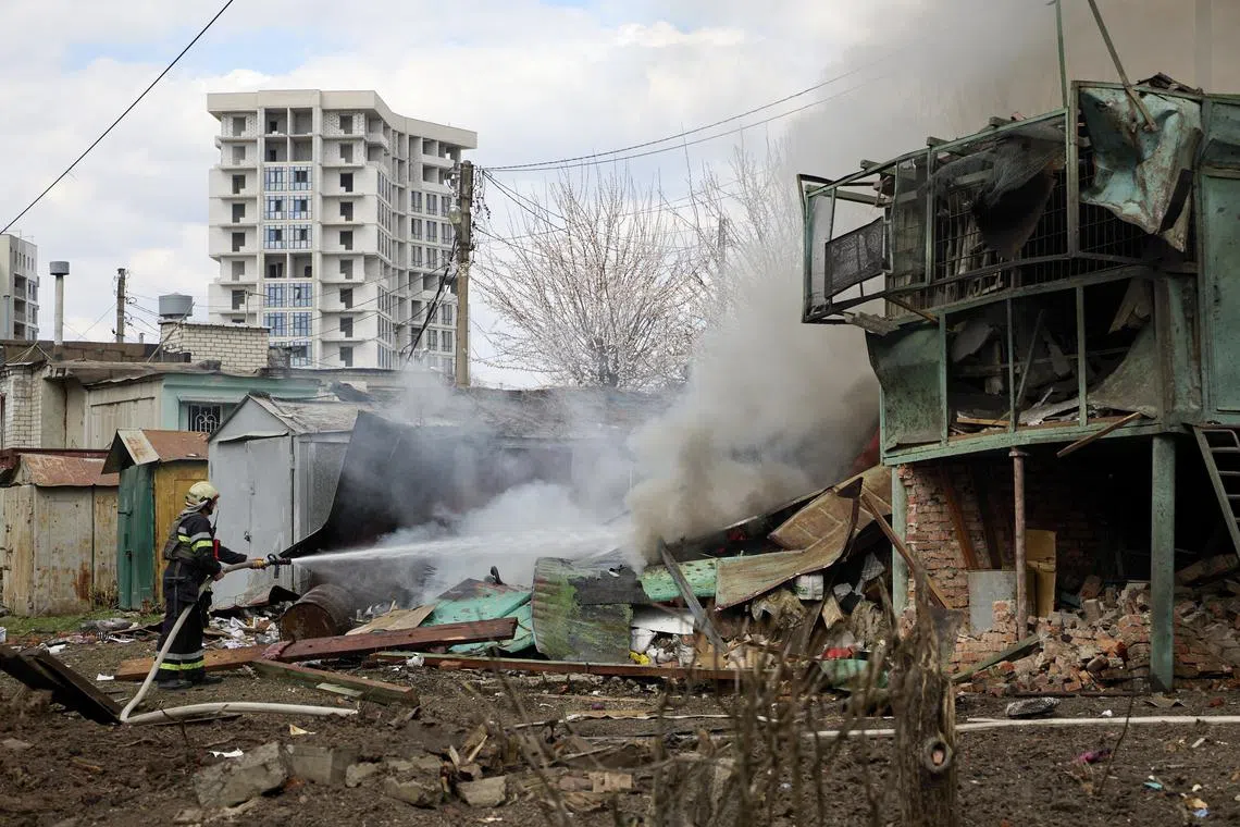 Ukrainian rescue services at the site of a rocket attack on a residential area in Kharkiv, northeastern Ukraine, on April 7.