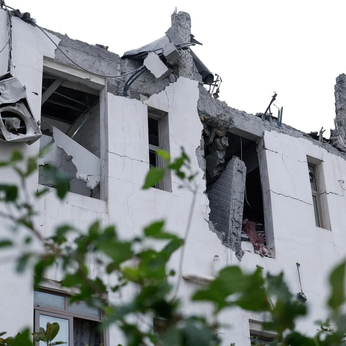 Damaged buildings at the site of an impact of what Bahrain's Ministry of Interior said was falling debris of an intercepted Iranian drone.