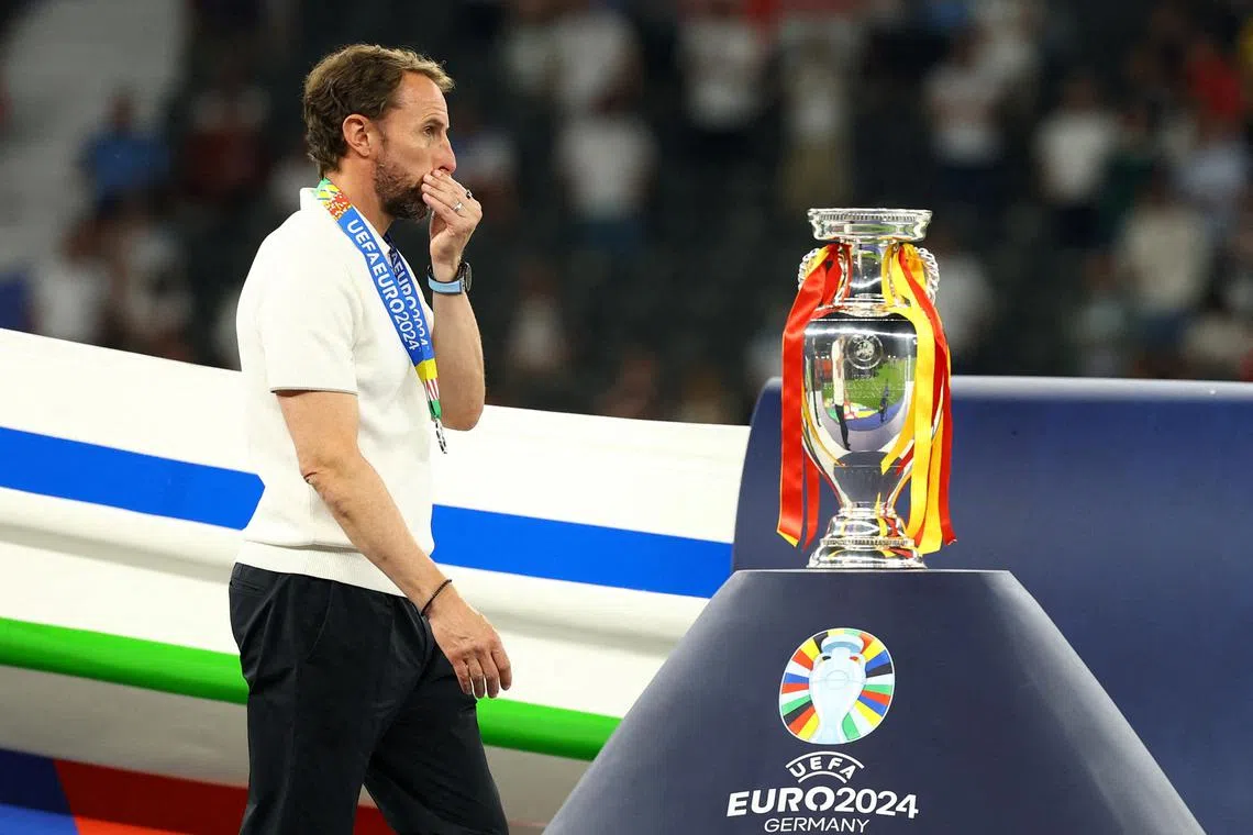 FILE PHOTO: Soccer Football - Euro 2024 - Final - Spain v England - Berlin Olympiastadion, Berlin, Germany - July 14, 2024 England manager Gareth Southgate looks dejected as he walks past the trophy after receiving his runners up medal REUTERS/Kai Pfaffenbach/File Photo