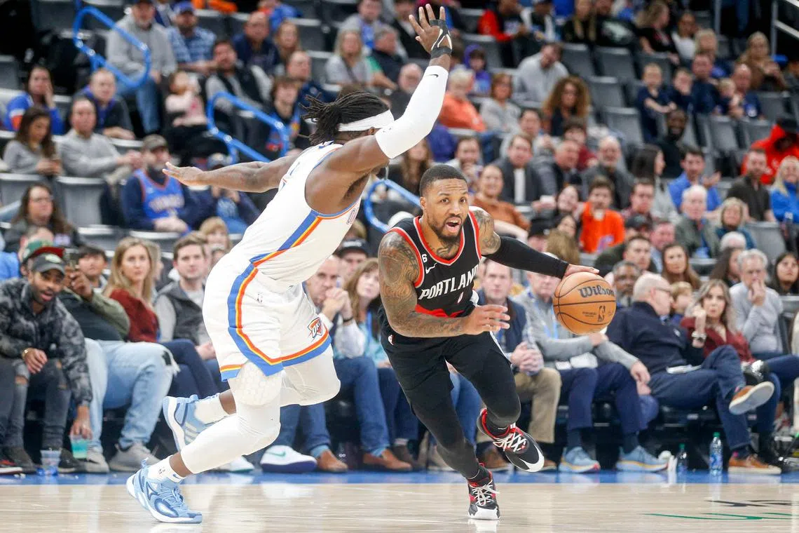 Damian Lillard of the Portland Trail Blazers driving past Luguentz Dort of the Oklahoma City Thunder during the fourth quarter at Paycom Centre on Monday in Oklahoma City. Lillard became Portland’s all-time leading scorer in the third quarter of the game, which they lost 123-121.
