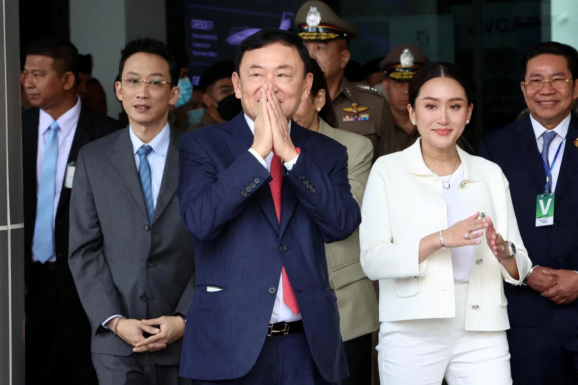 Former Thai prime minister Thaksin Shinawatra, accompanied by his daughter, Ms Paetongtarn Shinawatra, arriving at Don Mueang airport in Bangkok on Aug 22.
