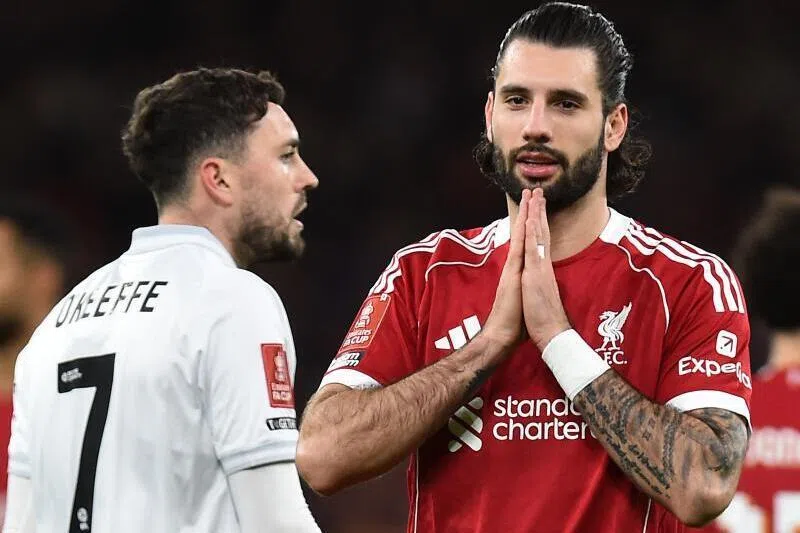 Liverpool's midfielder Dominik Szoboszlai (right) celebrates scoring the opening goal during the FA Cup third round football match against Barnsley on Jan 12, 2026.