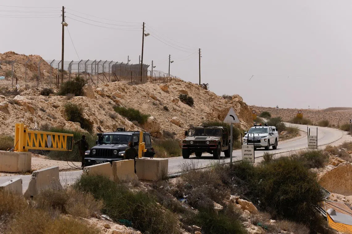 Vehicles approach the gate near the site of a reported security incident near Israel's southern border with Egypt on Saturday. 