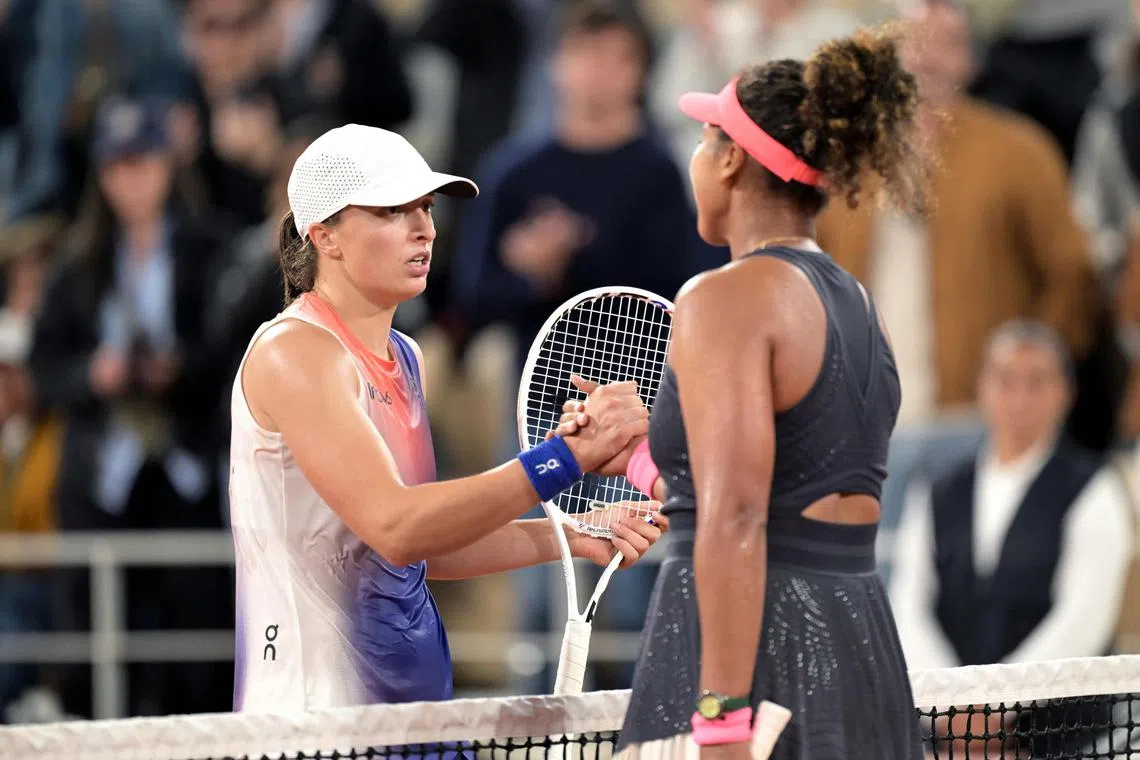 Iga Swiatek shaking hands with Naomi Osaka following a thrilling second-round clash at the French Open.