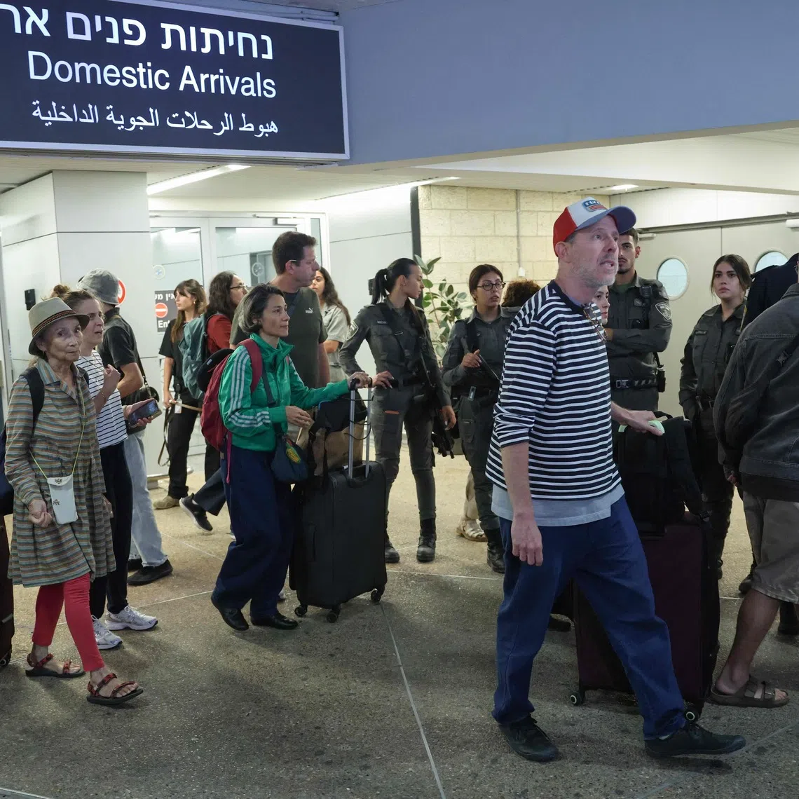 Passengers from a diverted flydubai flight are seen after landing at Israel’s Ben Gurion Airport in Lod on Sept 30.