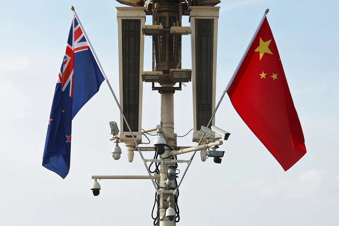 FILE PHOTO: Flags of New Zealand and China flutter near the Tiananmen Gate in Beijing, China June 19, 2025. REUTERS/Florence Lo/File photo