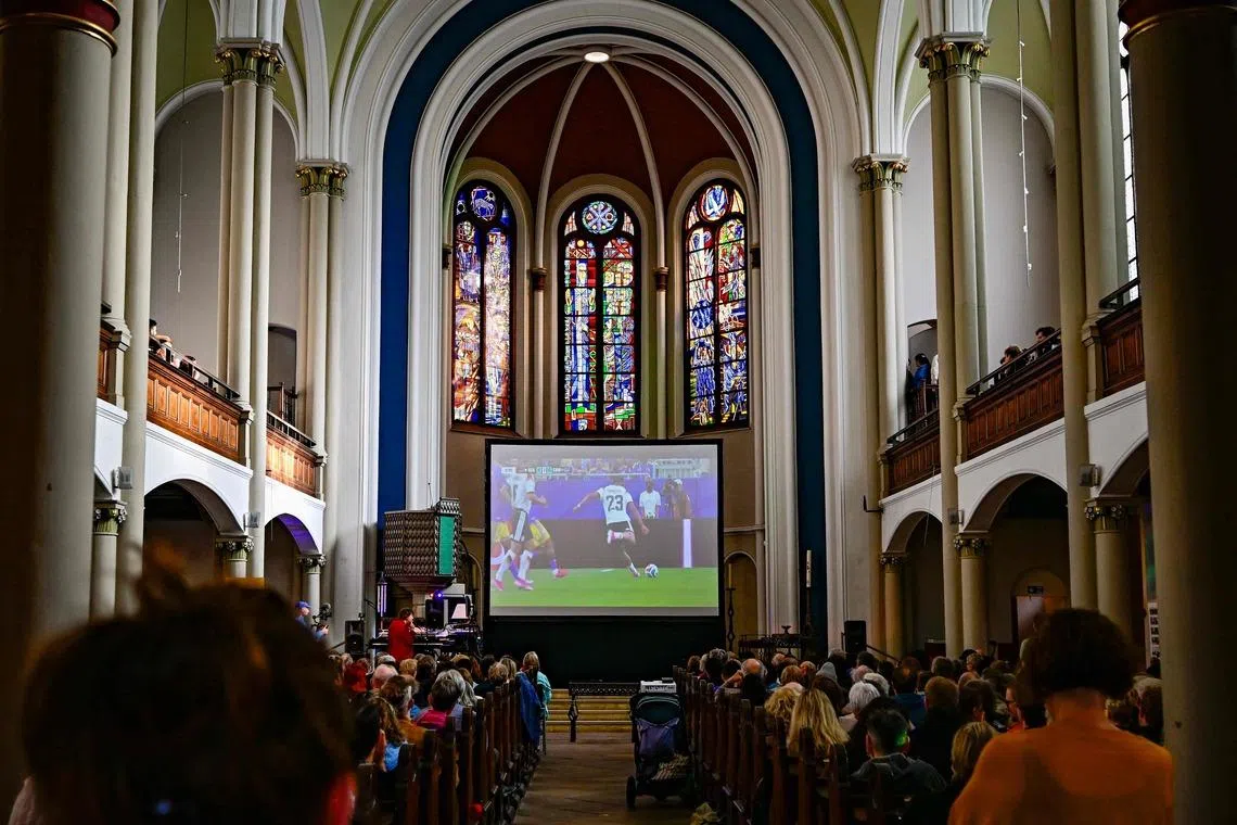 German fans attending the public screening of Germany's opening match at the 2026 World Cup against Curacao, at the Twelve Apostles Evangelical Church in Berlin, on June 14, 2026. 