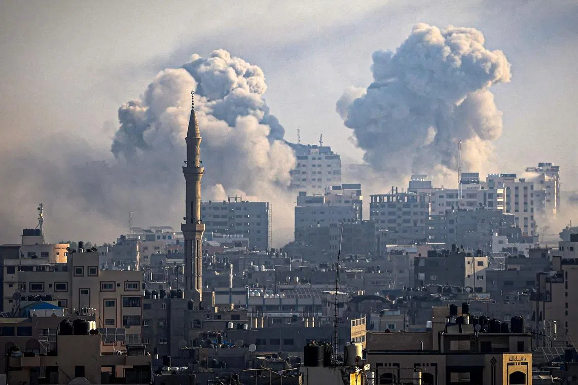 Smoke plumes billowing during Israeli air strikes in Gaza City on Oct 12.