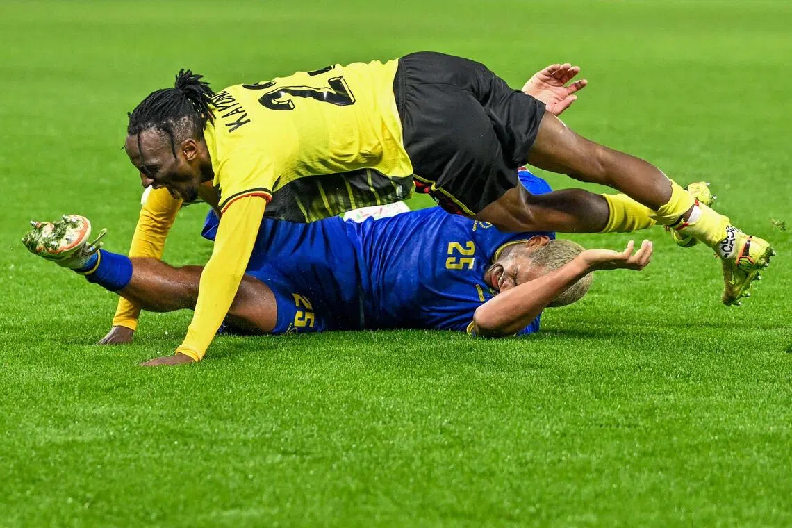 Uganda defender Aziz Kayondo falling on Tanzania midfielder Haji Mnoga after clashing in the Africa Cup of Nations (CAN) Group C football match at Al Medina Stadium in Rabat on Dec 27, 2025.