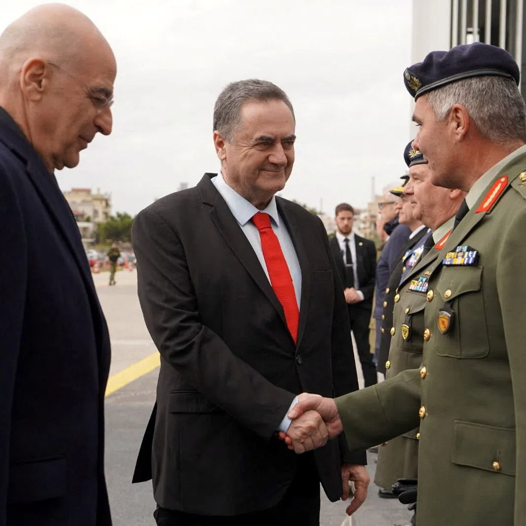 Israel Defence Minister Israel Katz shakes hands with General Director of the General Directorate for Defence Investments and Armaments (GDDIA) of Greece, Major General Ioannis Bouras, next to Greece's Minister for National Defence Nikolaos Dendias, during a visit in Greece on January 2026 in this handout image obtained by Reuters on August 31, 2026.  Israel Defence Ministry/Handout via REUTERS