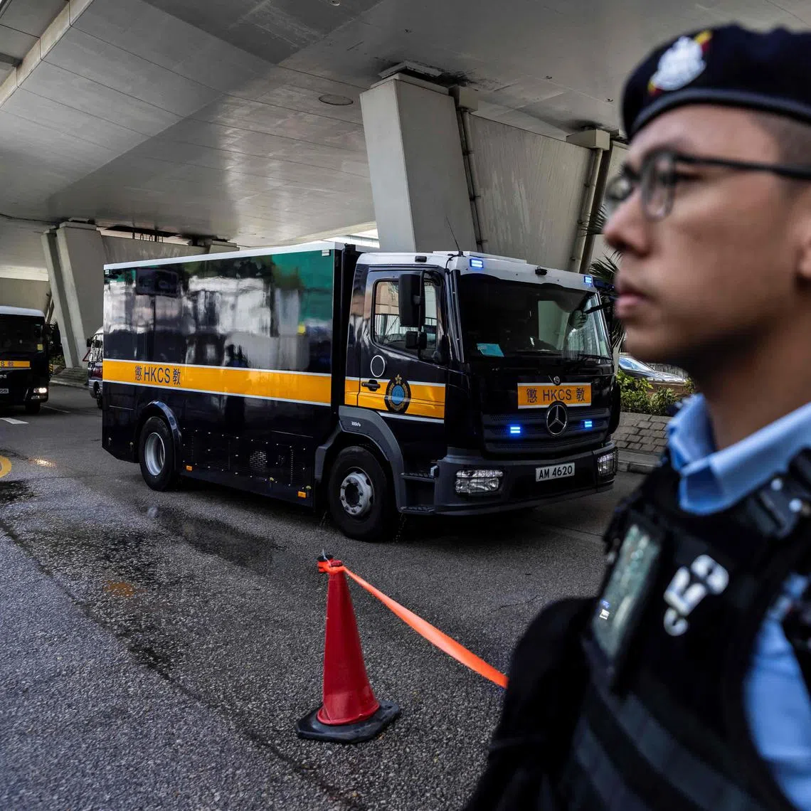 A correctional services van (L) holding Jimmy Lai arrives at the West Kowloon court after Hong Kong media mogul Jimmy Lai arrived for his  national security trial in Hong Kong on August 15, 2025. Jailed Hong Kong media mogul Jimmy Lai's national security trial, which began in late 2023, will enter its final stages on August 15, as lawyers present closing arguments. (Photo by ISAAC LAWRENCE / AFP)